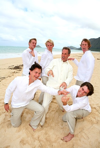 The kids in their leis on the sand, from another angle