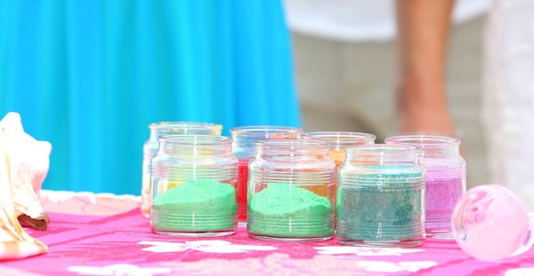 The family pouring the rainbow sand together, smiling