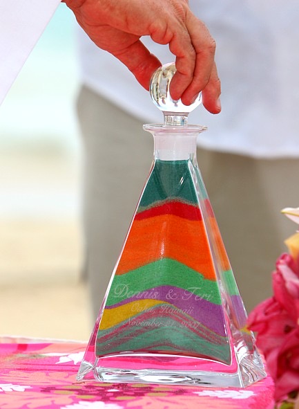 The family pouring the rainbow sand together, from another angle