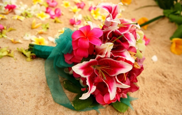 Tropical bright pinks Hawaii bouquet on the sand