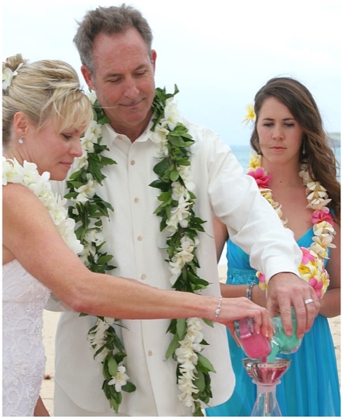 Teri and husband pouring sand at their wedding