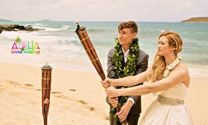 Jill and James lighting the fire torch at their Makapuu beach wedding