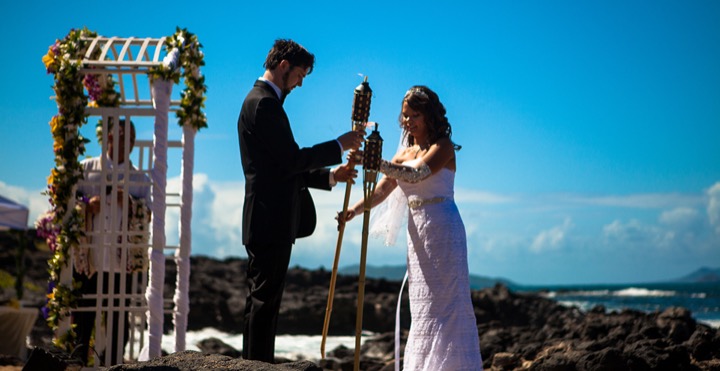 Stephanie and Ryan lighting the unity tiki torch at Makapuu