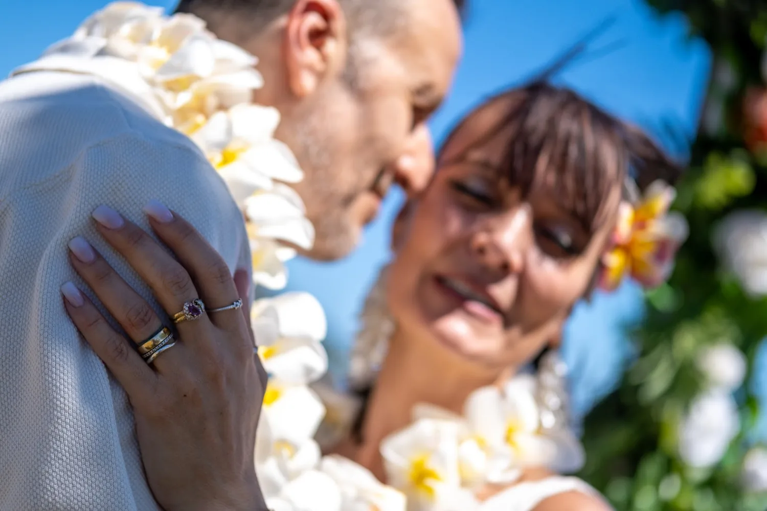 Cheek to cheek in their leis