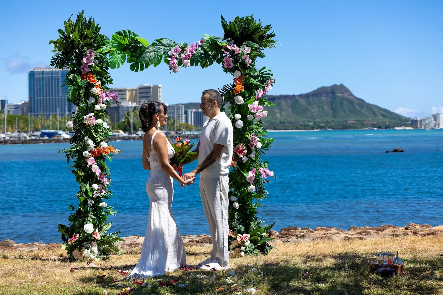 Steve and Sara at the flower arch with Diamond Head behind them