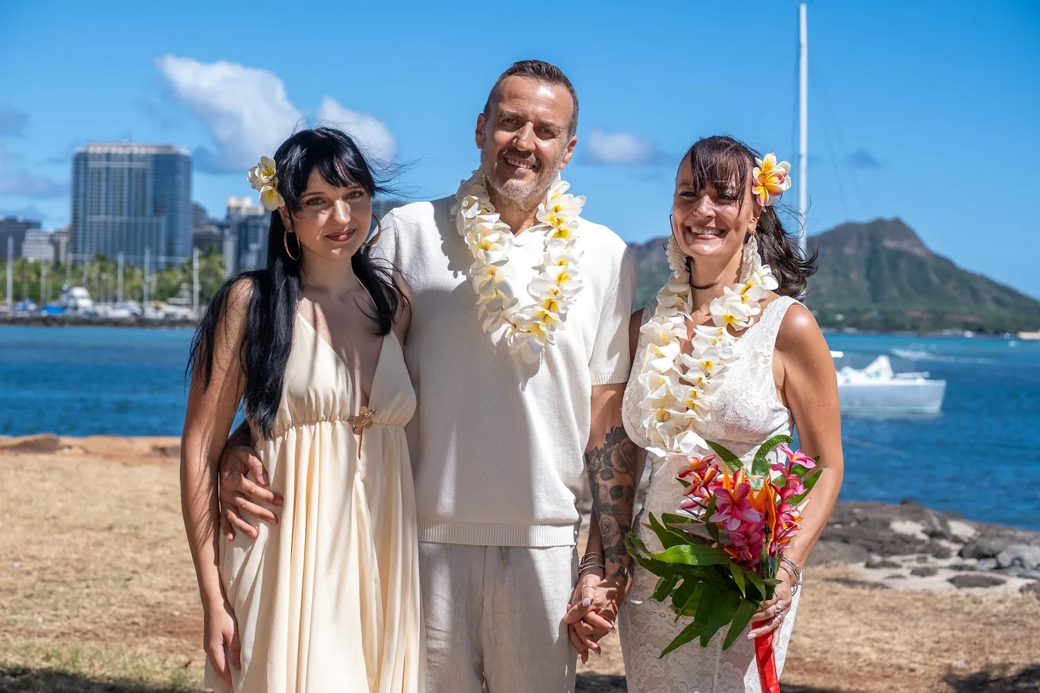 Family portrait in leis by the water