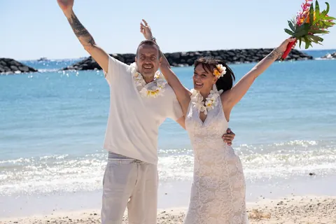 Arms up with joy on the beach