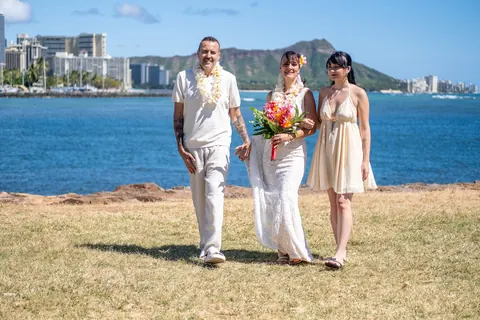 Family photo on the grass with the city behind