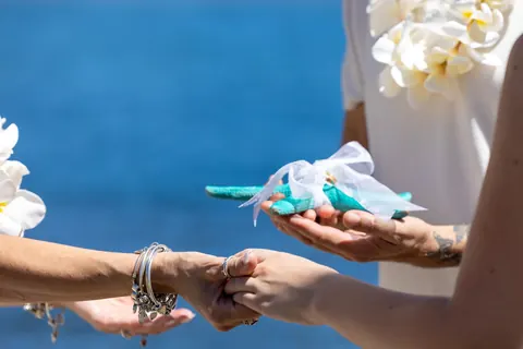 The rings being passed in a seashell