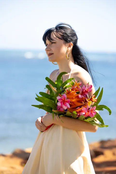 Close up of Sara holding her tropical bouquet
