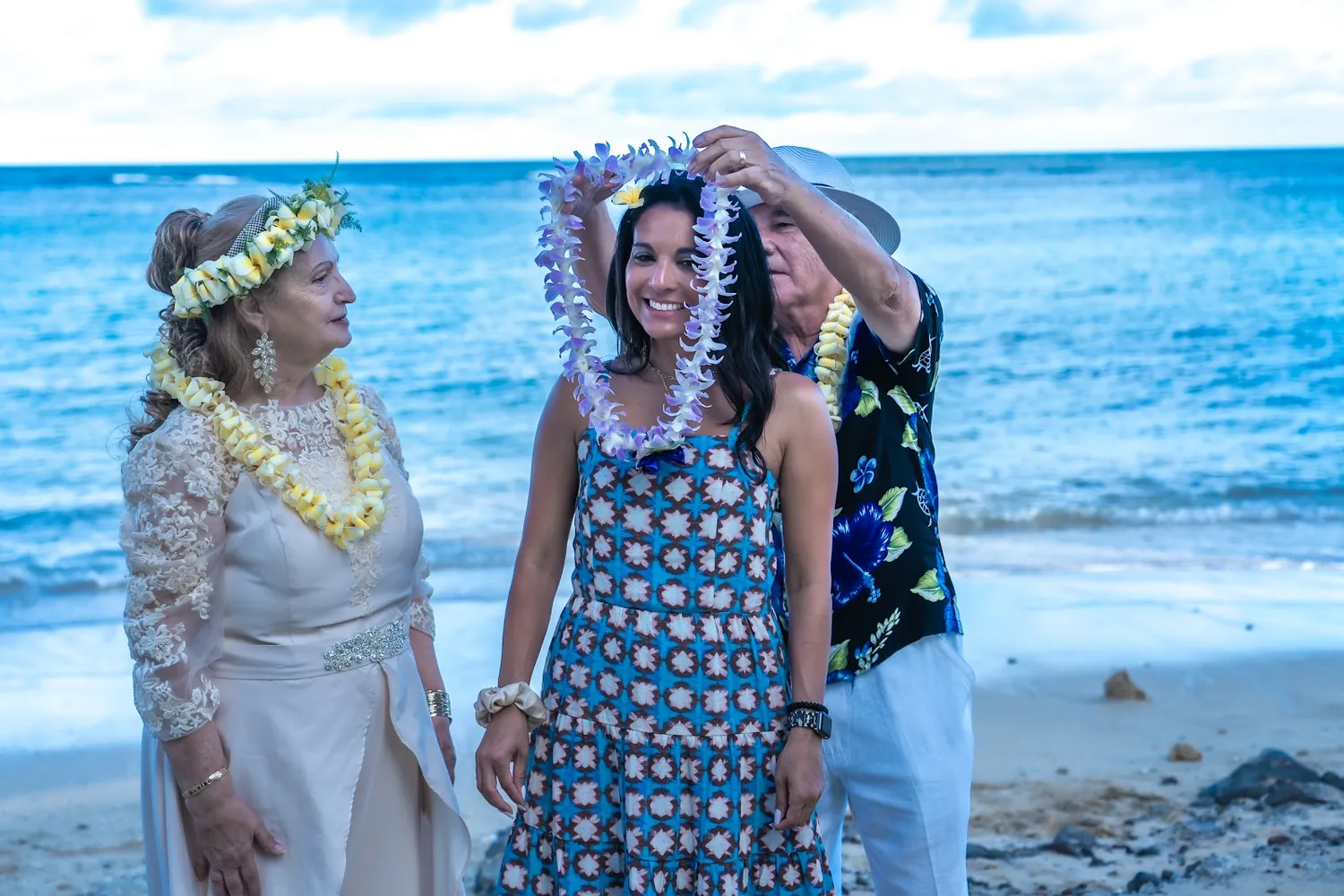 A lei exchange with family by the sea