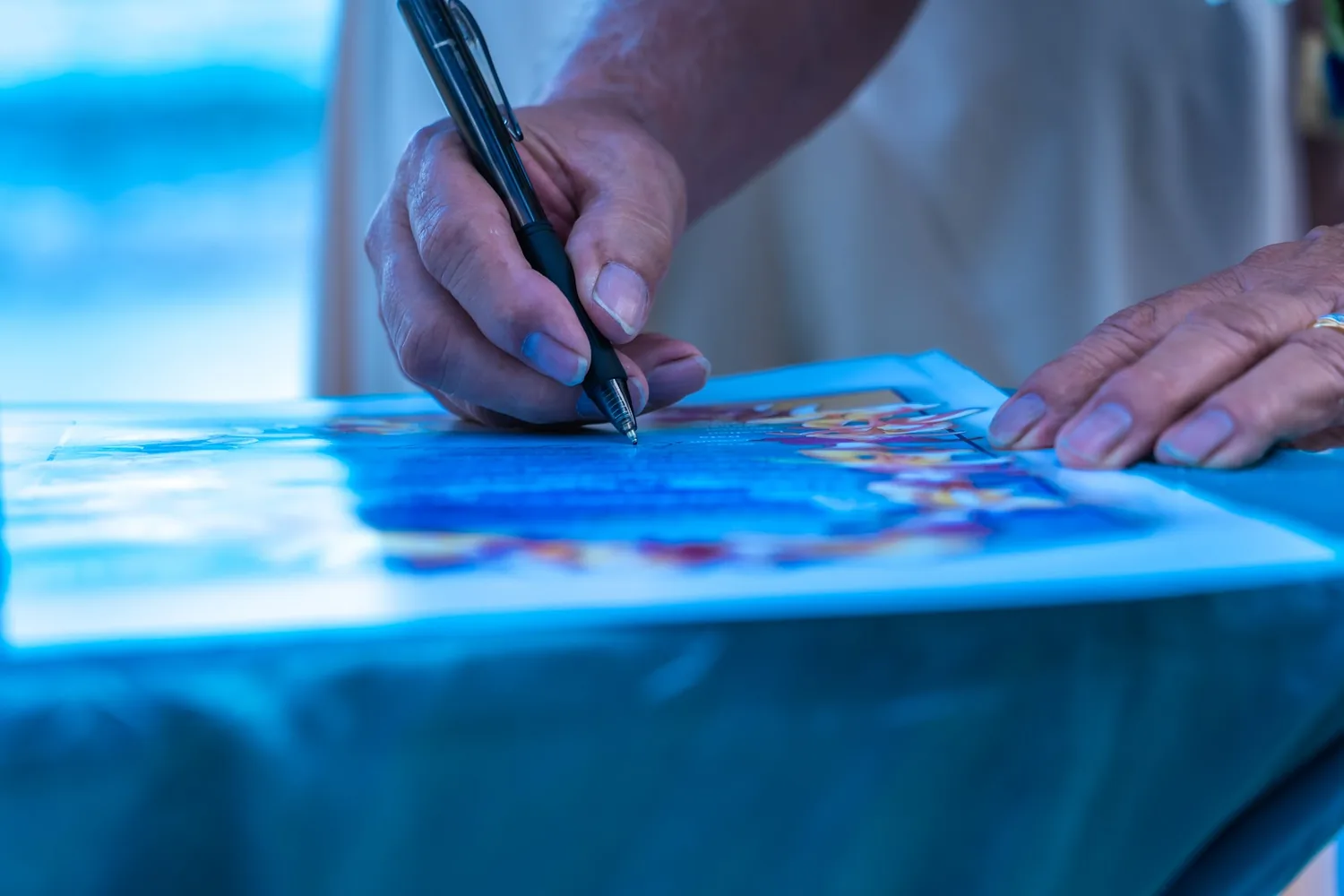 Close up of signing the vow renewal certificate
