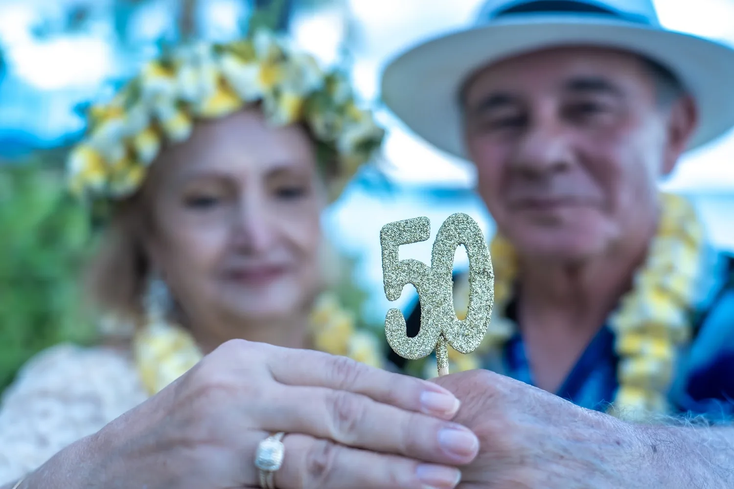 Daniel and Shirley holding a golden 50 topper