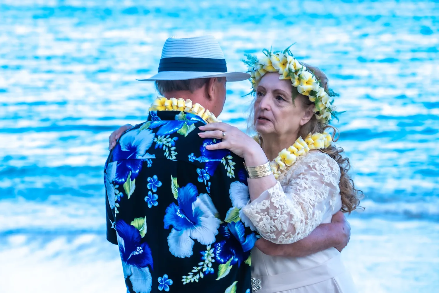 Daniel and Shirley in a warm embrace by the sea
