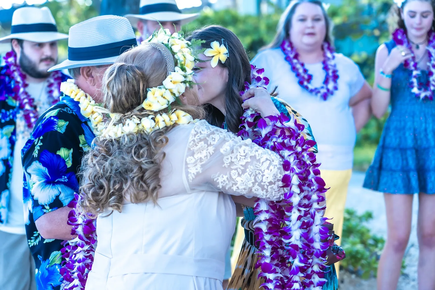 Daniel placing a lei on family