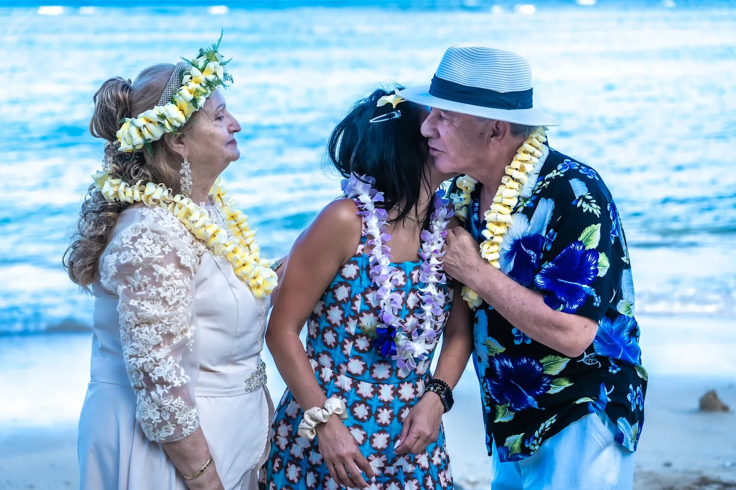 Giving a purple orchid lei to family