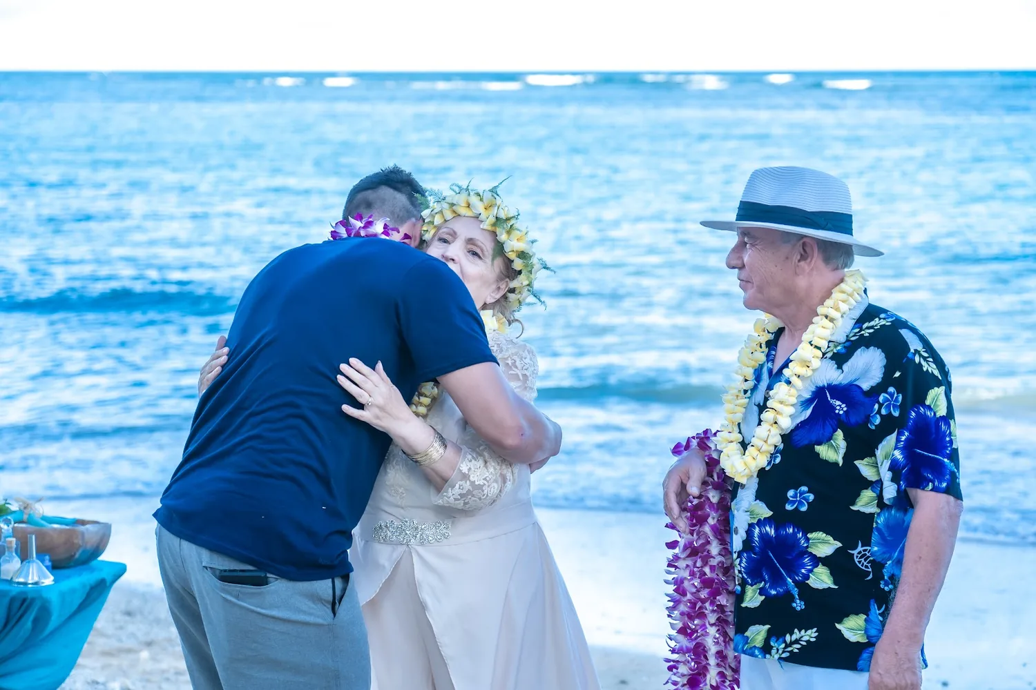Giving leis to family members on the beach