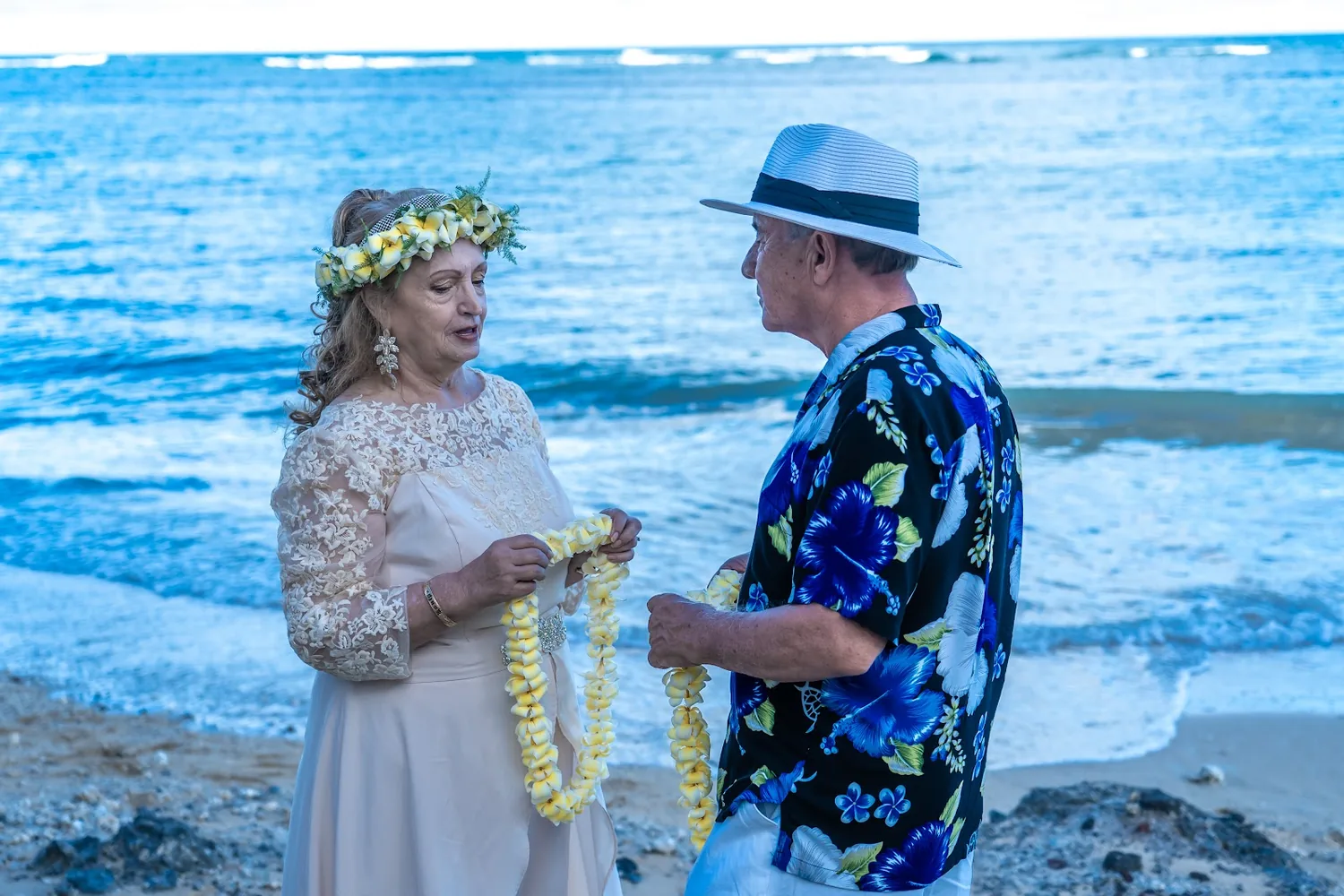 Holding hands as the ceremony begins by the sea