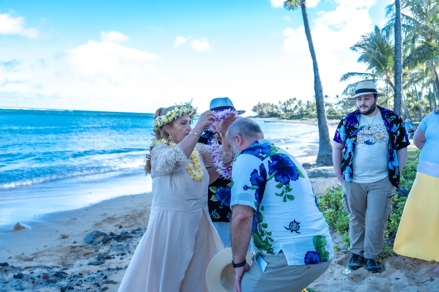 The ceremony on the sand with family watching