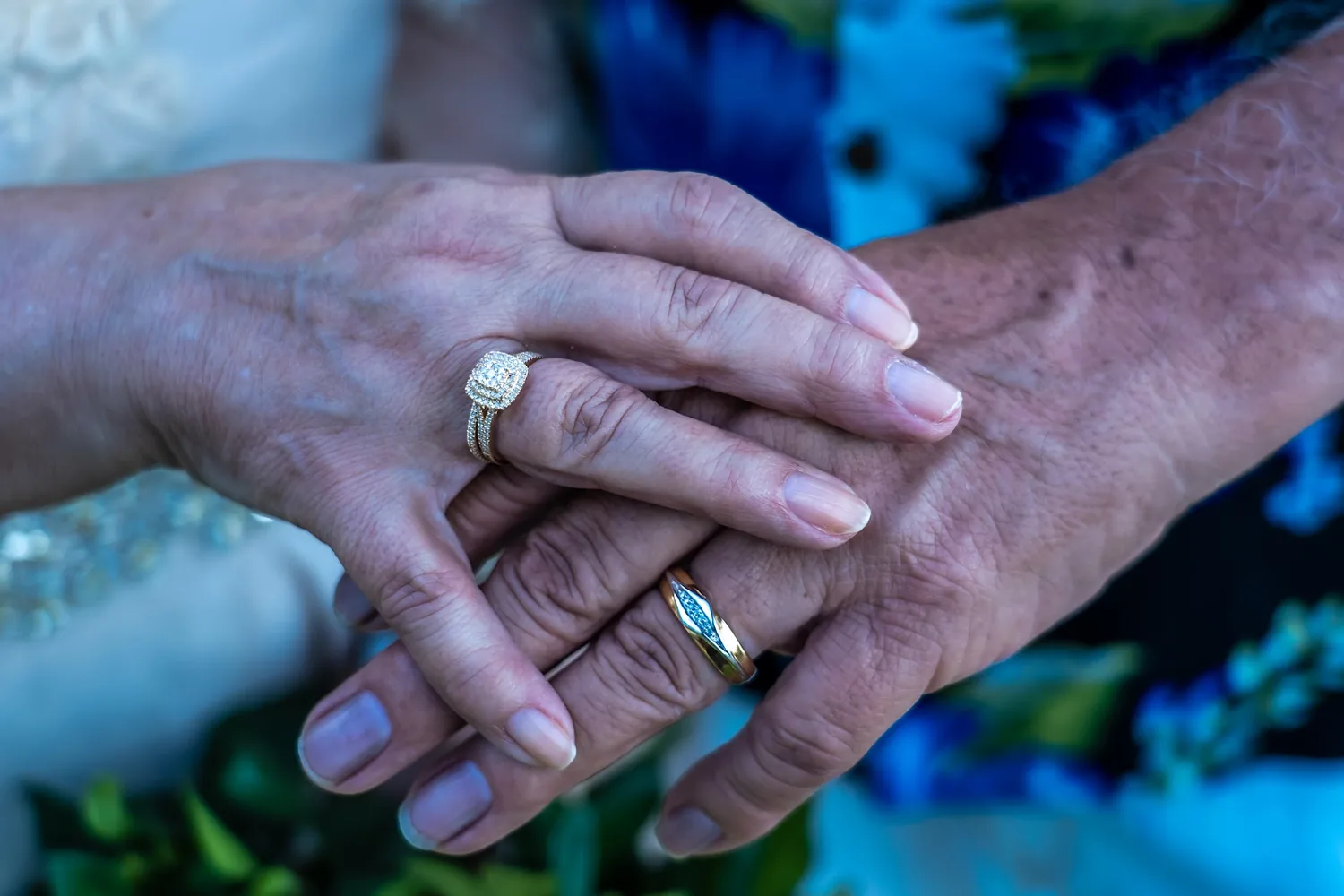 Their hands and wedding rings up close