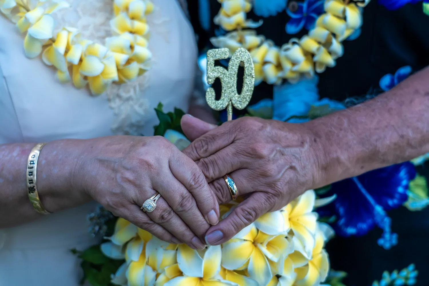 Their rings with a golden 50 and yellow plumerias