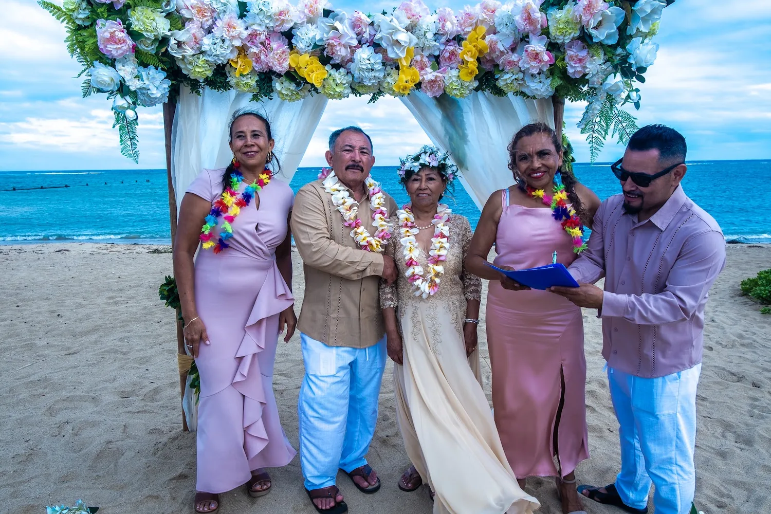Family photo by the ocean under the arch
