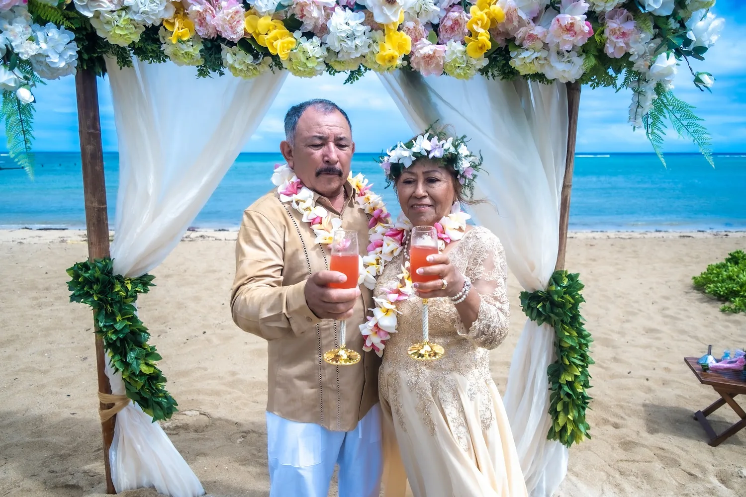 Raising a toast with pink drinks under the arch