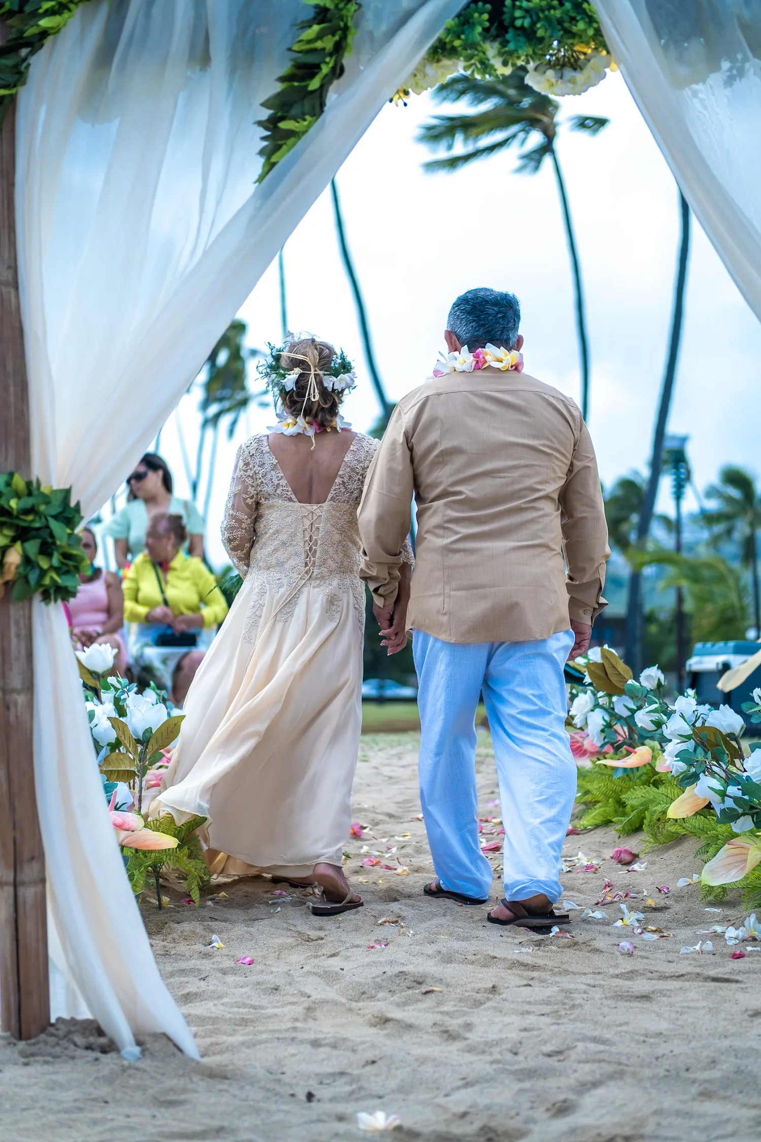 A kiss by the arch after the ceremony