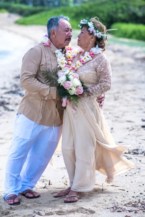 Her white bouquet and lace gown up close