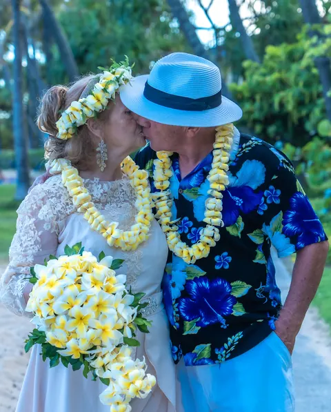 A kiss in their yellow leis and Shirley's white plumeria bouquet