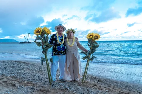 Daniel and Shirley between the sunflowers at the end of the day