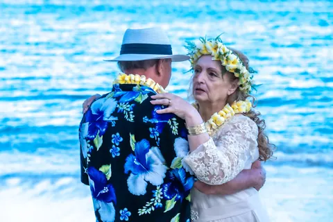 Daniel and Shirley in a warm embrace by the sea