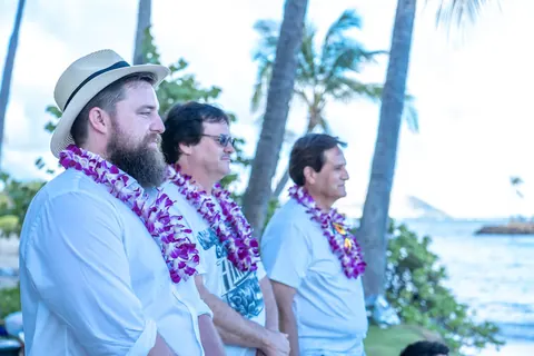 Family in purple orchid leis