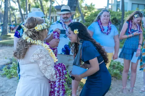 Laughing with family in their leis