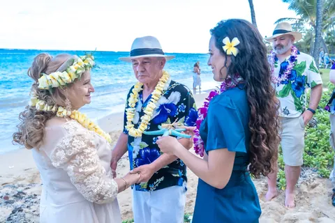 Shirley giving a lei to a granddaughter