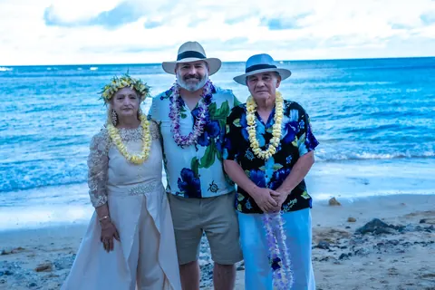 Standing together by the sea with their family