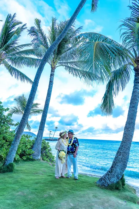 The couple under the palm trees at Kahala