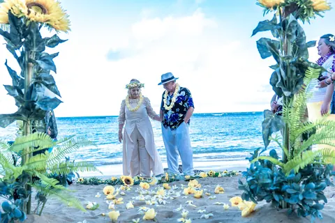 The yellow plumeria walkway on the sand leading to the couple
