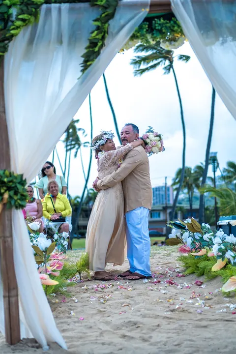 An embrace on the beach after the vows