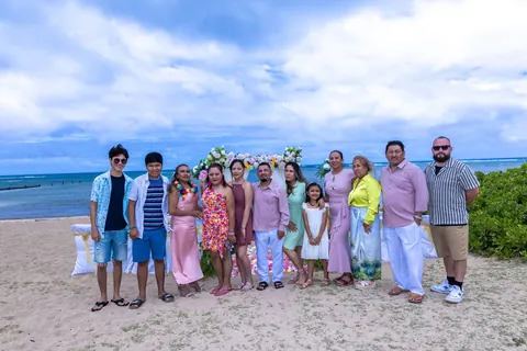 The family arriving on the beach in aloha shirts and dresses