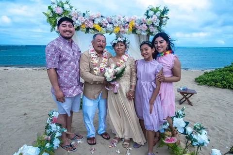 Family group by the arch on the sand