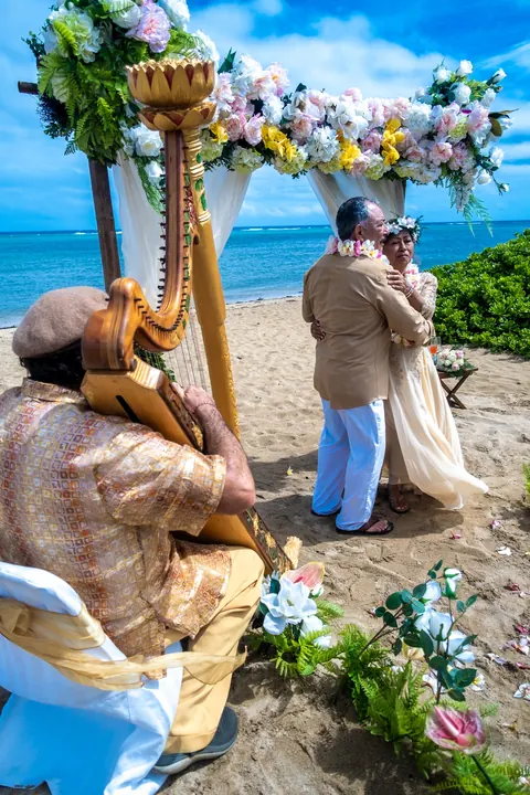 The harpist playing as the couple stands together