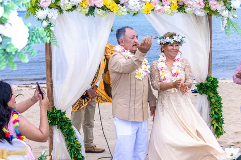 Giving a pink plumeria lei