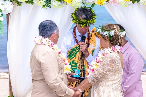 The couple receiving a blessing with a ti leaf