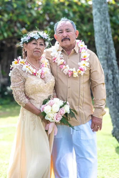 Together after 50 years, with her bouquet and their leis