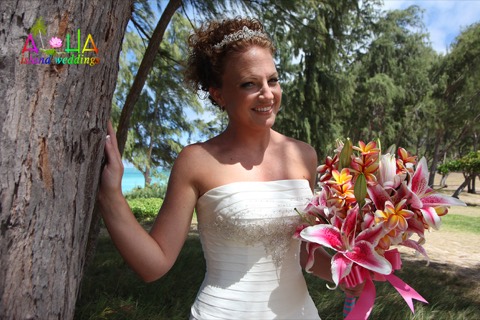 Karissa with her stargazer bouquet by a tree near the beach
