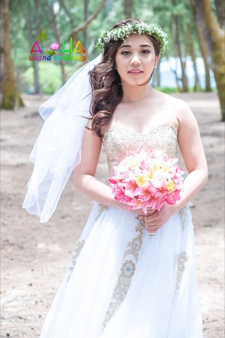 A bride with her pink bouquet before her wedding at Waimanalo