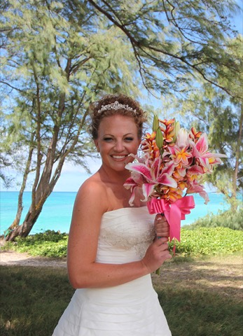 Karissa holding her bright tropical bouquet before the ceremony
