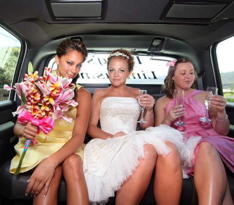 Karissa and her bridesmaids laughing in the limo on the way to the beach