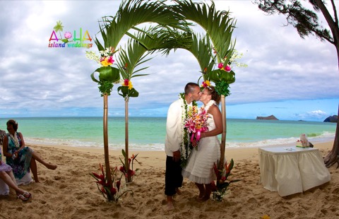 Karissa and Brian kiss under the palm archway